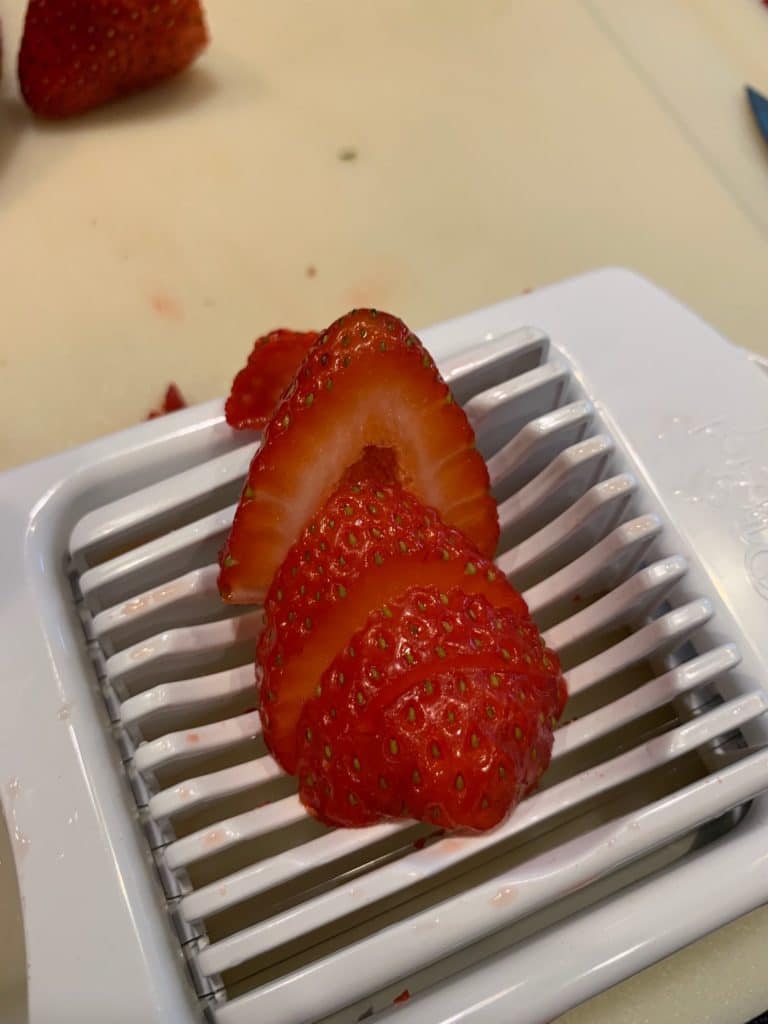Sliced strawberries for a flag fruit pizza