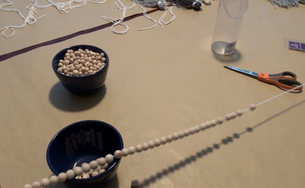 Making the beaded string for a BoHo Tassel Garland, inspired by Pottery Barn Teen