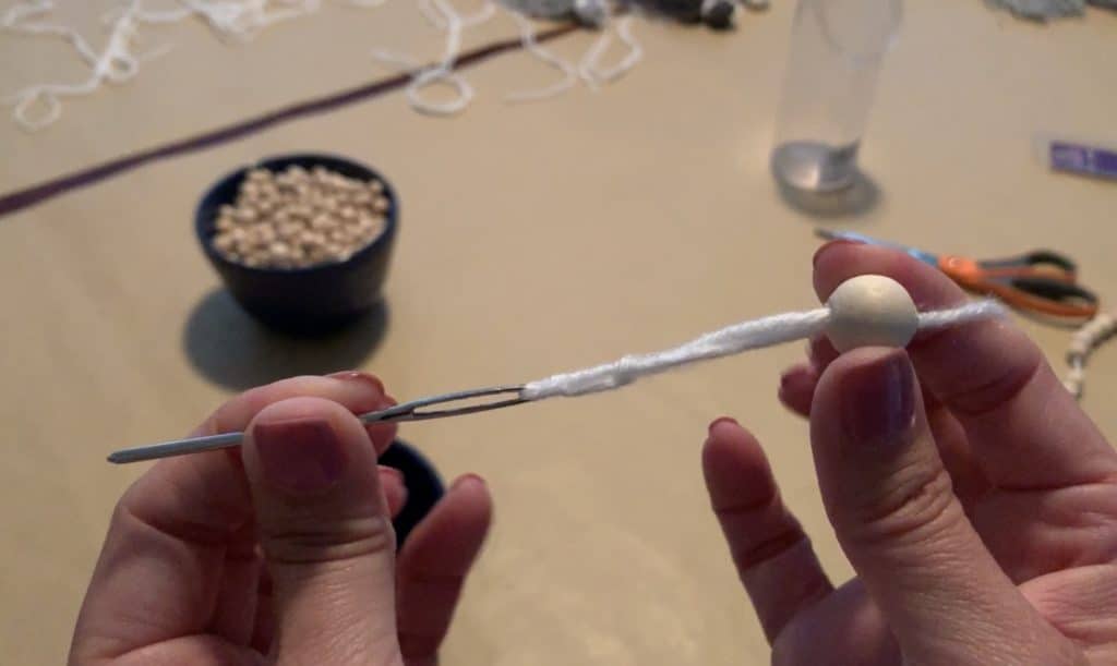 threading needle for a wood bead