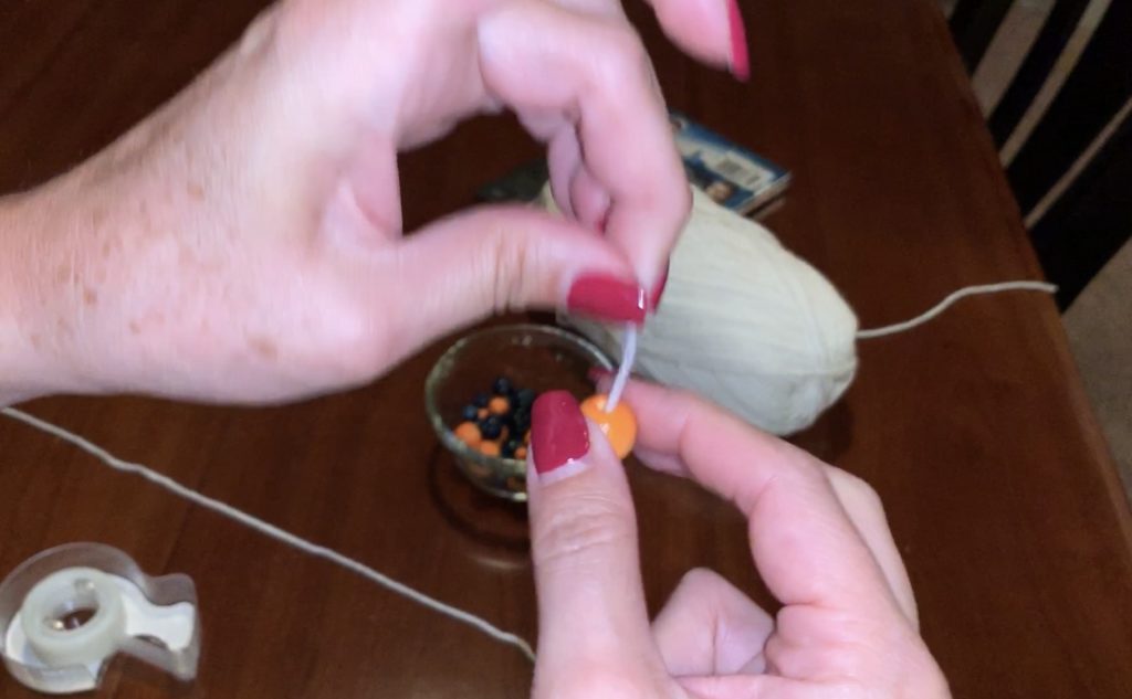 Threading beads onto yarn