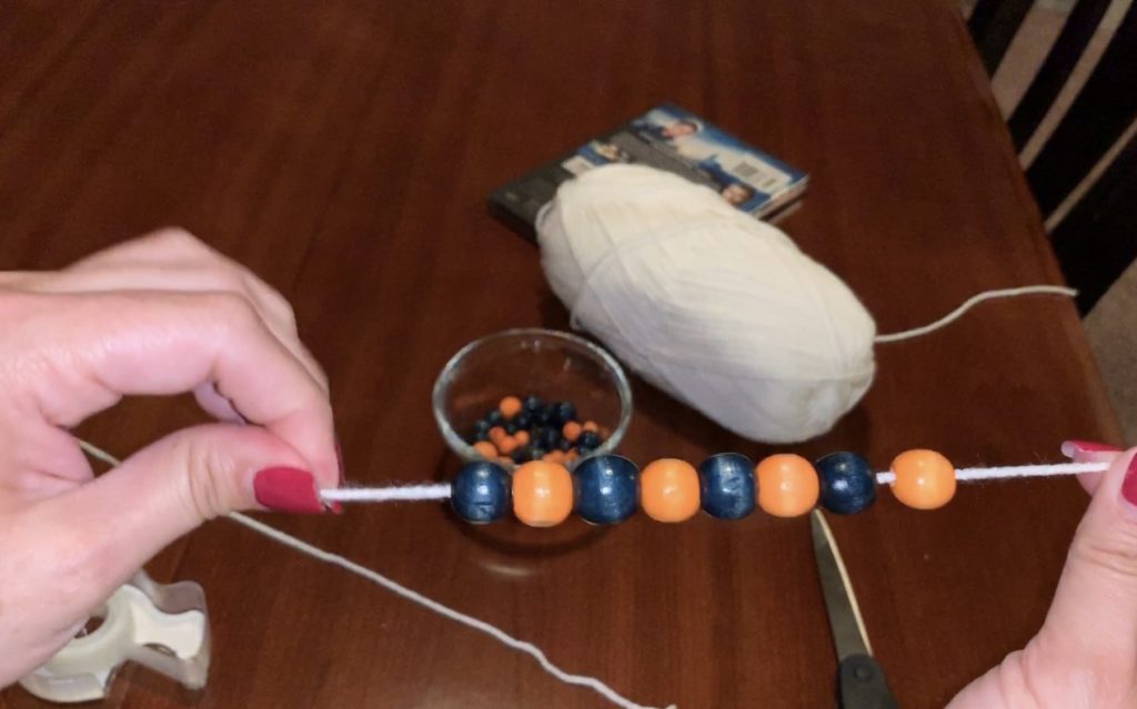 Threading beads onto yarn
