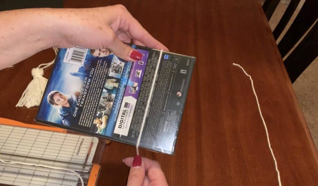 Wrapping yarn around template to make a yarn tassel