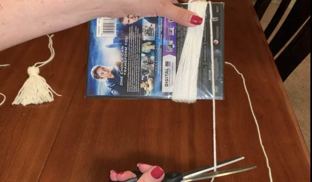 Wrapping yarn around template to make a yarn tassel