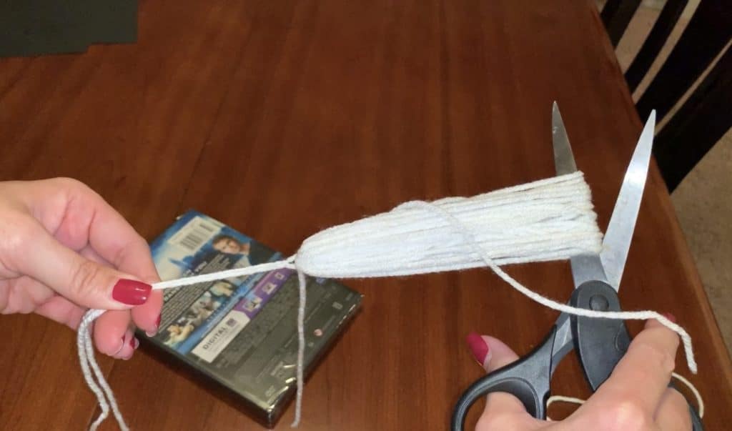 Cut the yarn tassel loop when making tassels for ghost tassel garland