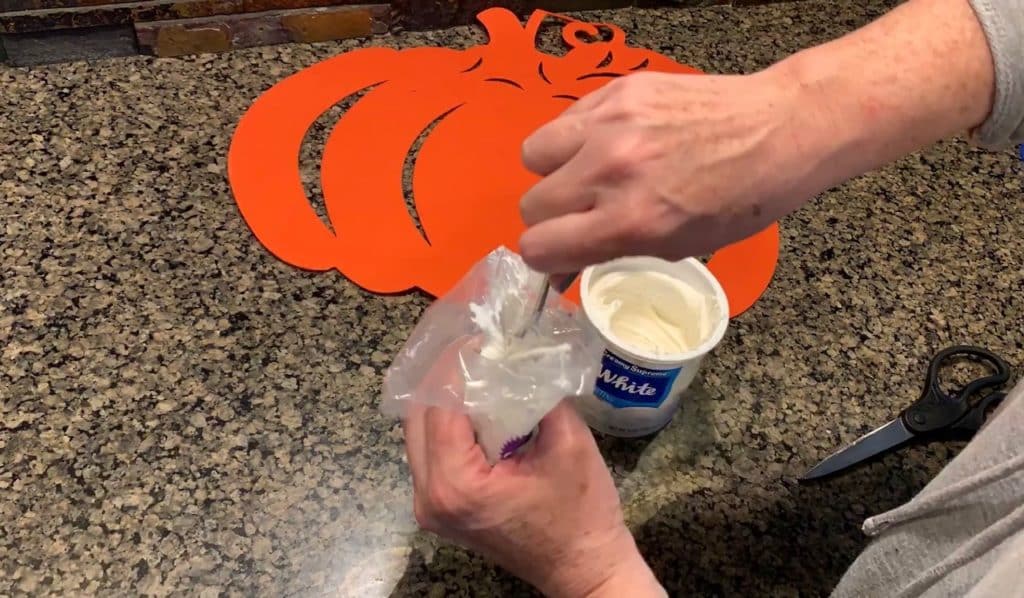Put frosting into a decorating bag or Ziplock bag