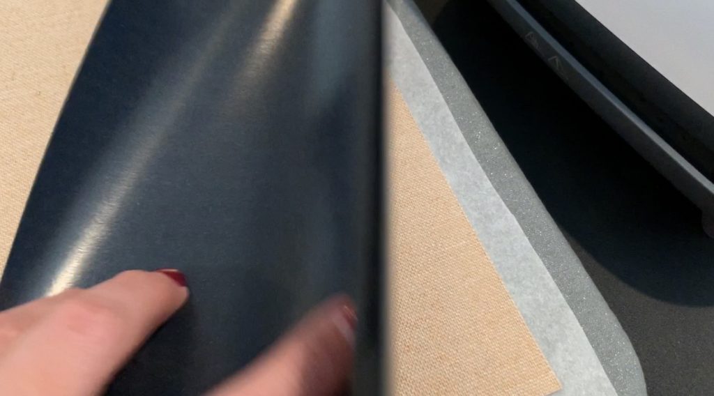 iron everyday heat transfer material onto the back of a cork sheet with a Cricut Easy Press