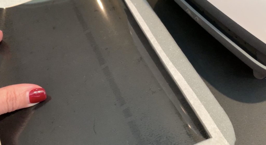 iron everyday heat transfer material onto the back of a cork sheet with a Cricut Easy Press