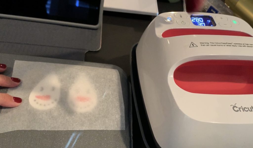 Parchment paper on earrings before Cricut Easy Press