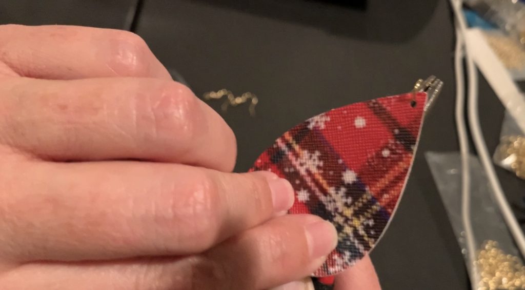 Puttnig the earring components onto the hooks and jump rings