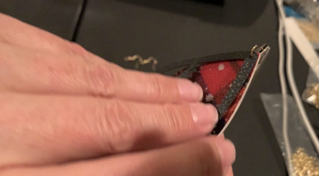 Puttnig the earring components onto the hooks and jump rings