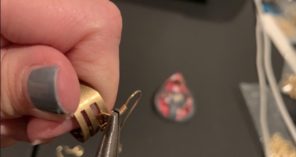 Puttnig the earring components onto the hooks and jump rings