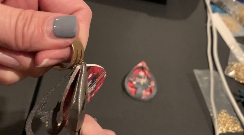 Puttnig the earring components onto the hooks and jump rings