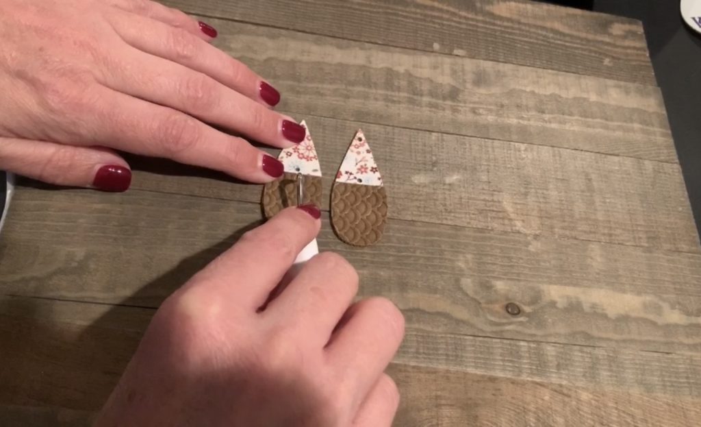 poking hole in faux leather earring with Cricut weeder