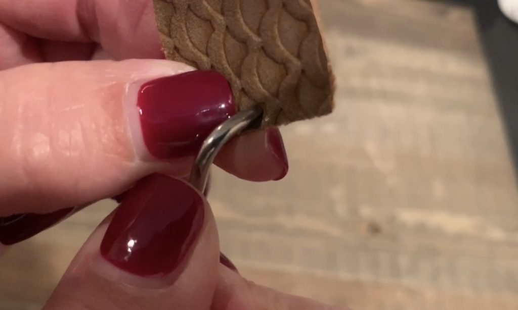 poking hole in faux leather earring with Cricut weeder