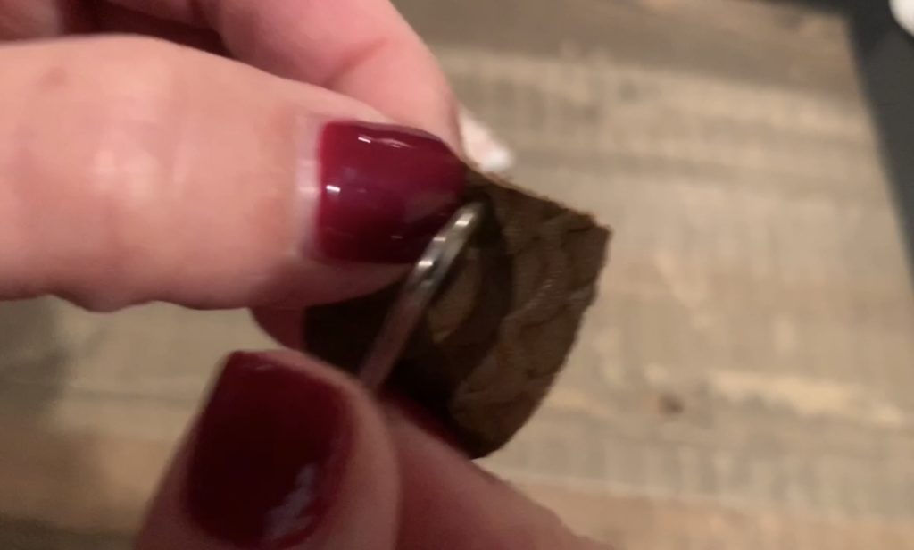 poking hole in faux leather earring with Cricut weeder