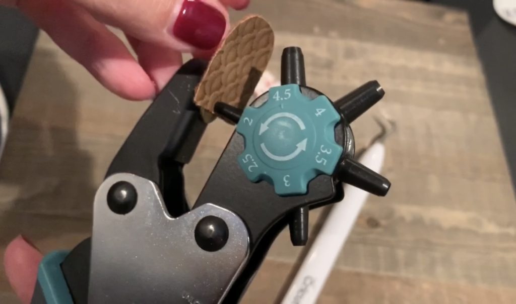 punching hole in diy faux leather earring with leather punch