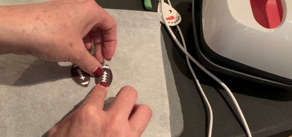 ironing football markings onto football faux leather earrings