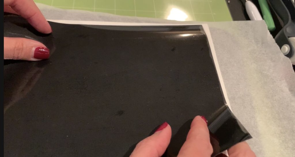 Cricut heat transfer vinyl ironed onto back of faux leather