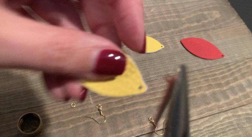 punch hole in football faux leather earrings