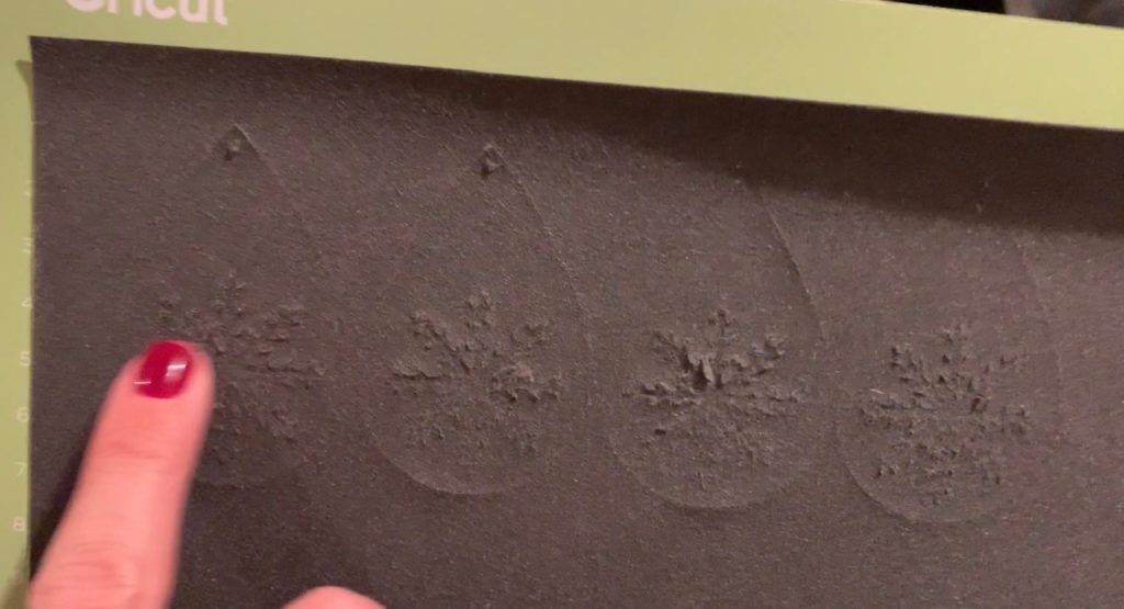 making snowflake faux leather earrings on the Cricut machine