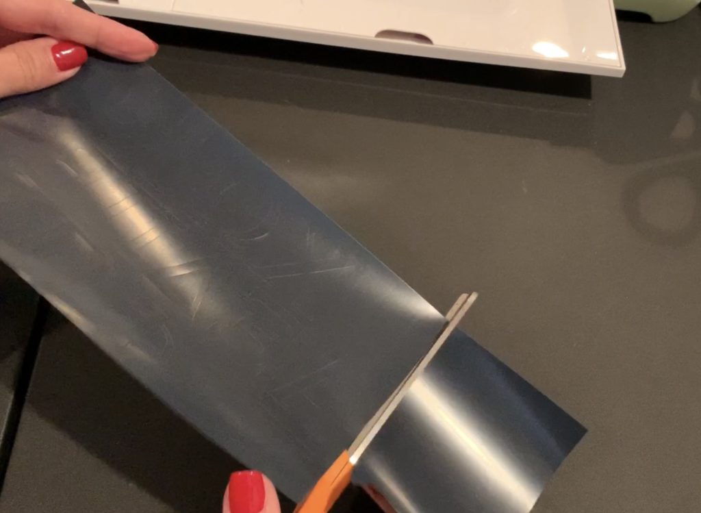 black heat transfer vinyl cut and ready to apply with a Cricut Easy Press