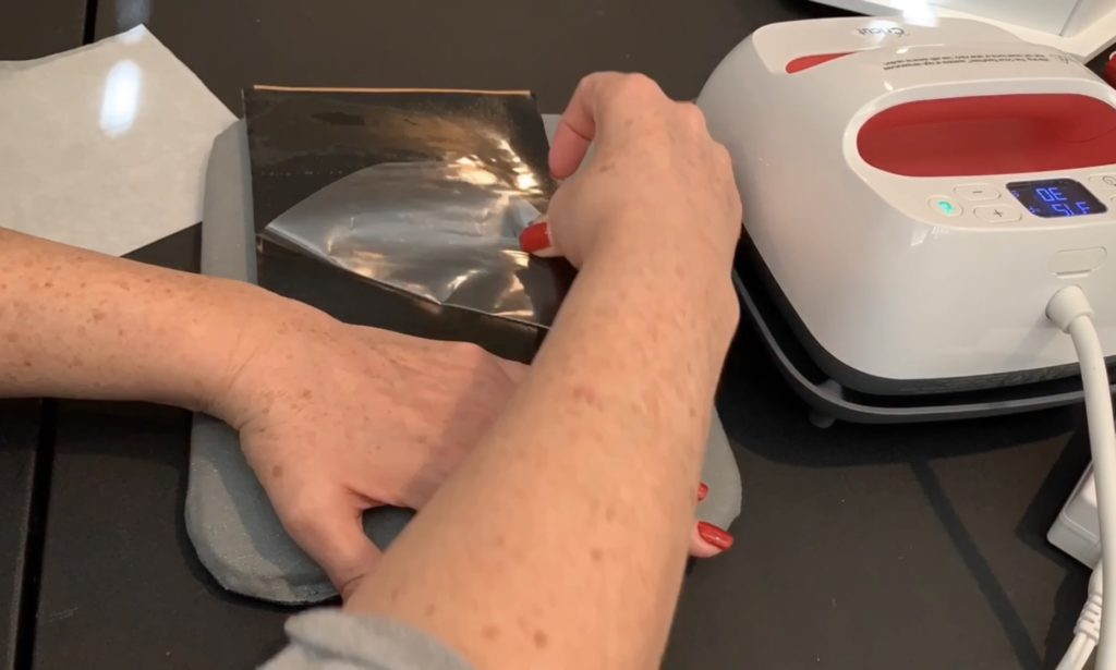 applying heat transfer vinyl (HTV) to the back of a sheet of cork  to make diy tree earrings 