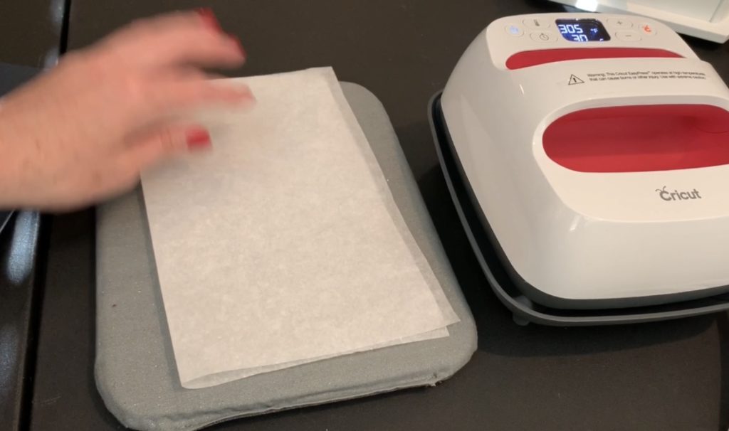 applying heat transfer vinyl (HTV) to the back of a sheet of cork  to make diy tree earrings