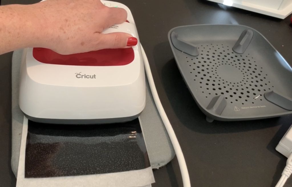 applying heat transfer vinyl (HTV) to the back of a sheet of cork  to make diy tree earrings
