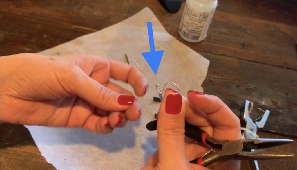 opened up end of hook just a bit to allow the metal bar to fit