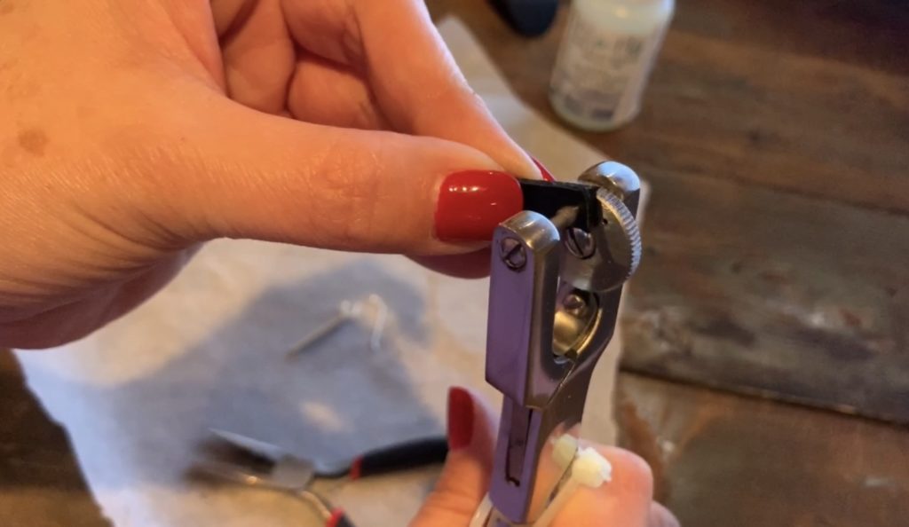 punching a leather bar diy earring with a leather hole punch