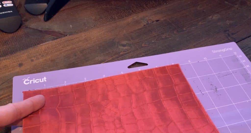 Place genuine leather onto the purple strong grip mat, with the good side of the leather facing down