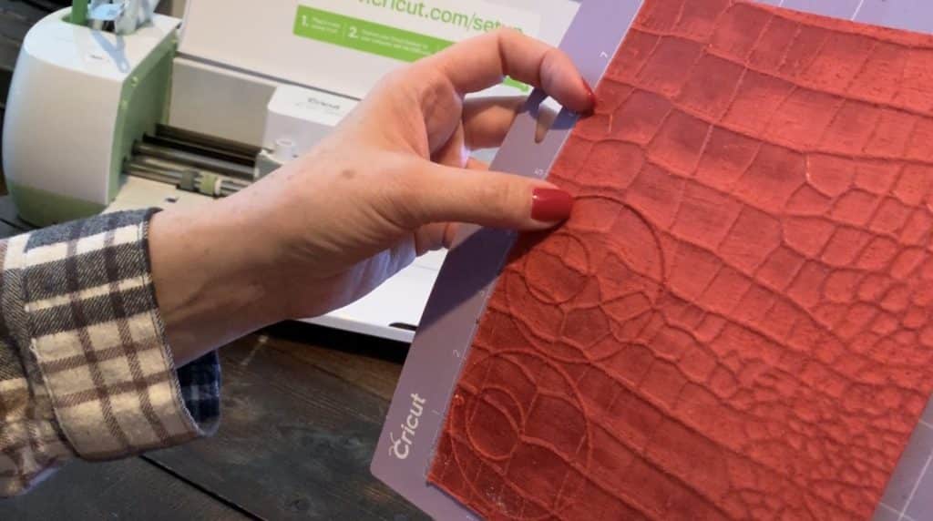 genuine leather sheet on Cricut mat, where you can see the earring cuts on the leather