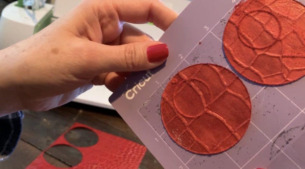 genuine leather sheet on Cricut mat, where you can see the earring cuts on the leather