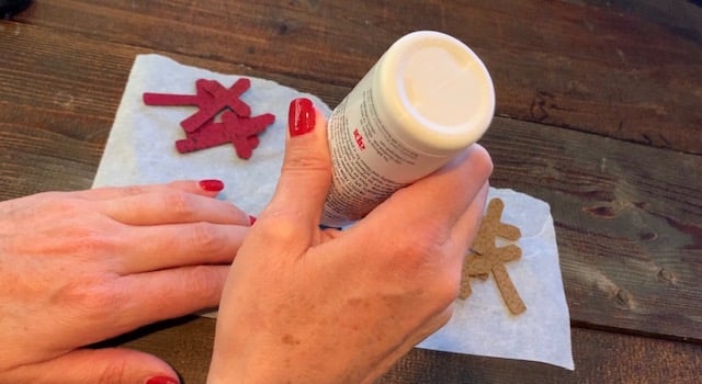 Adding glue onto the cross leather earrings diy so that they can be glued front to back