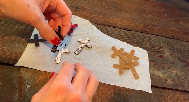 Adding glue onto the cross leather earrings diy so that they can be glued front to back