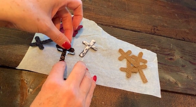 Adding glue onto the cross leather earrings diy so that they can be glued front to back