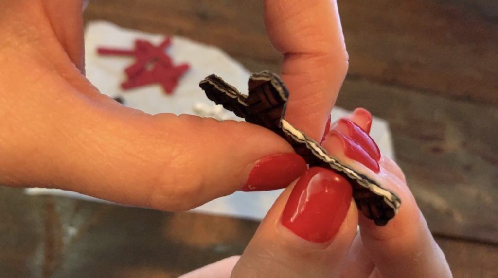 Adding glue onto the cross leather earrings diy so that they can be glued front to back