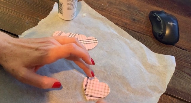 Gluing faux leather heart earrings together, front and back