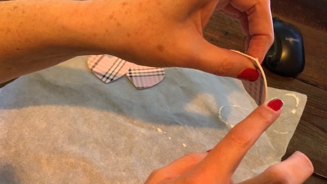 Gluing faux leather heart earrings together, front and back