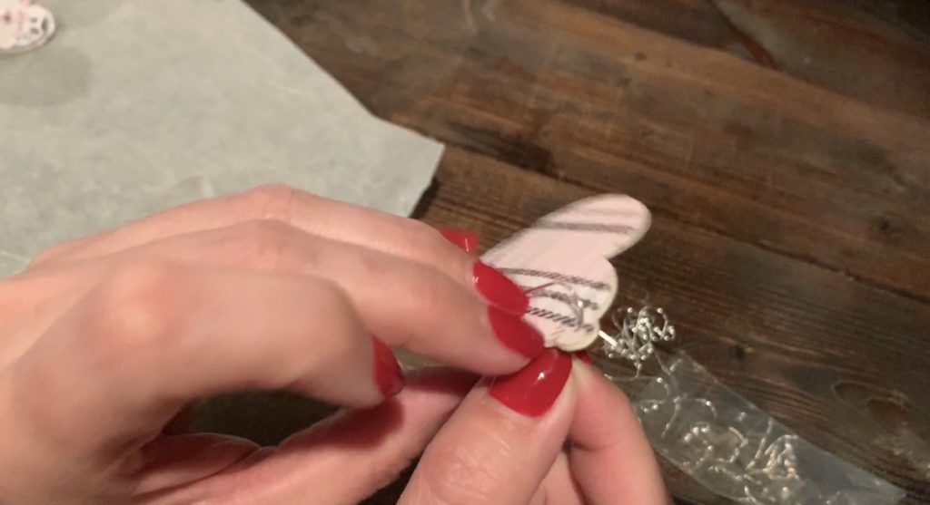 Putting hooks onto the Valentine's Day earrings DIY project
