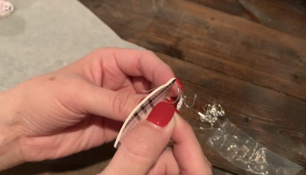 Putting hooks onto the Valentine's Day earrings DIY project