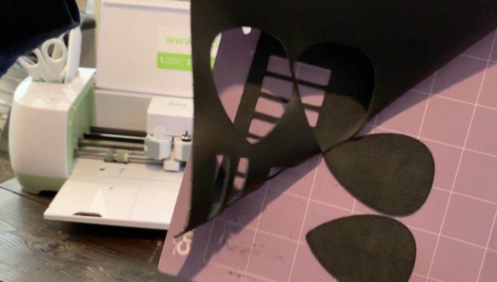 leather teardrop earrings after being cut on a Cricut machine