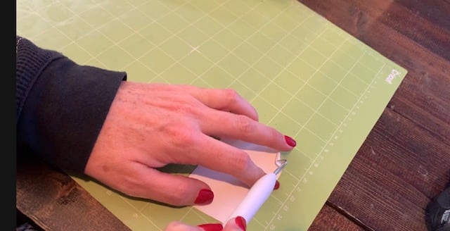 weeding heat transfer vinyl (HTV) with a Cricut weeder so that it can be ironed onto diy earrings