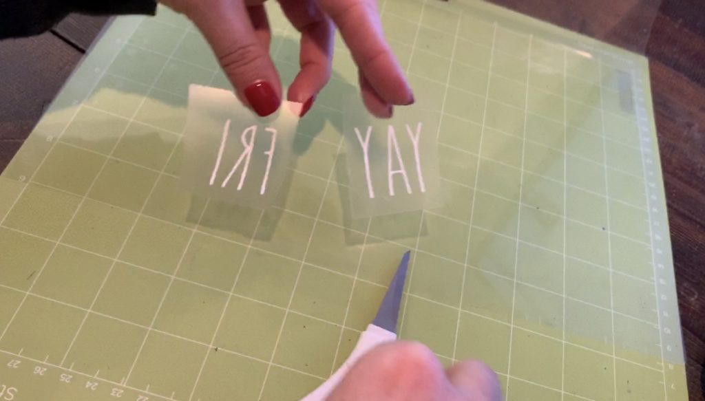 heat transfer vinyl (HTV) with weeding complete and ready to iron onto the the leather earrings