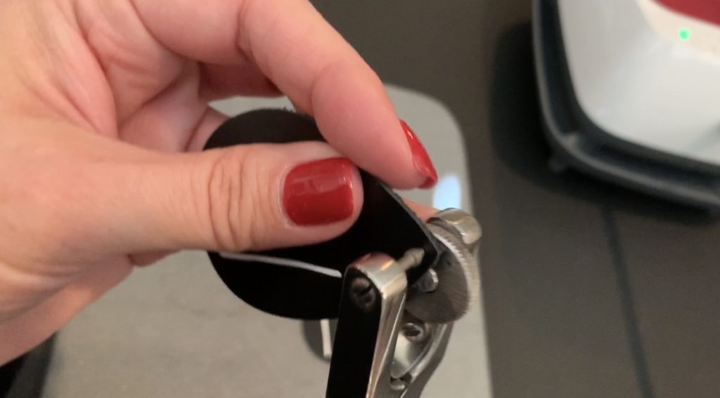 punching hole into the leather teardrop diy earrings