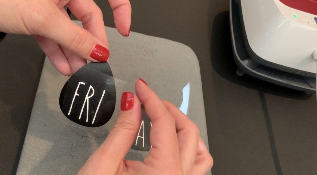 Taking off the heat transfer vinyl backing after applying heat