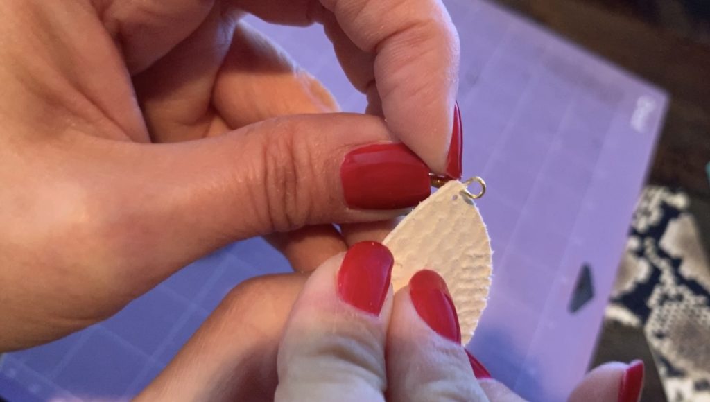 putting the leather earring onto the earring hook
