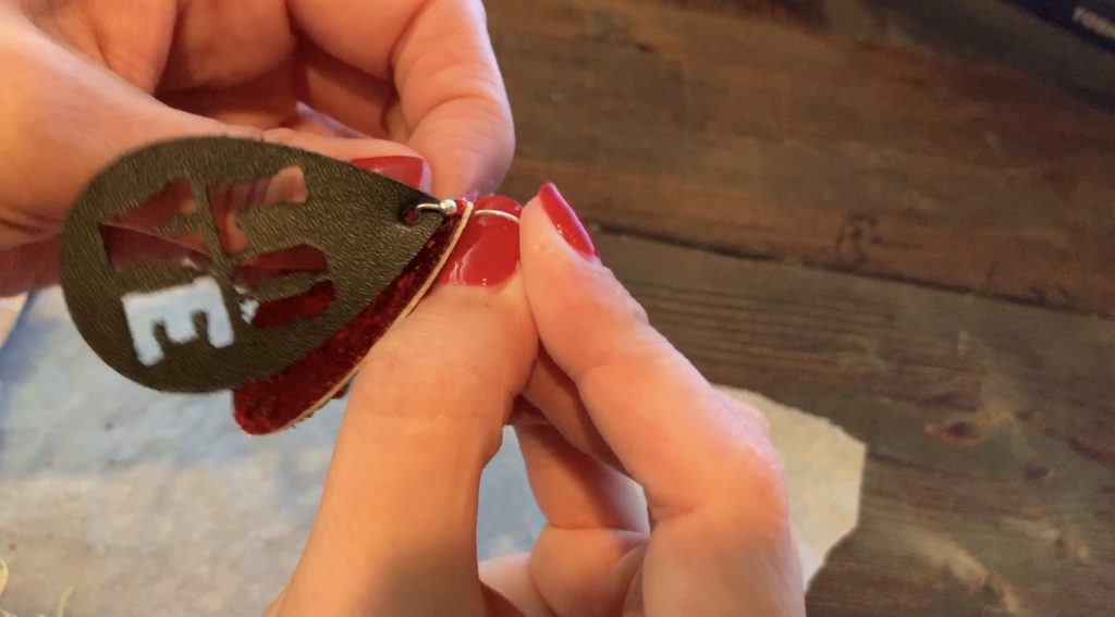 Putting Love earrings diy onto the hooks for Valentine's Day earrings