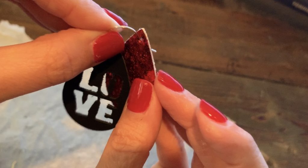 Putting Love earrings diy onto the hooks for Valentine's Day earrings