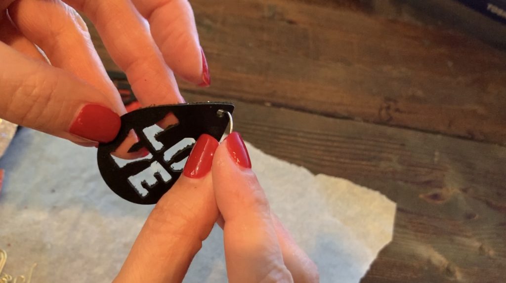 Putting Love earrings diy onto the hooks for Valentine's Day earrings